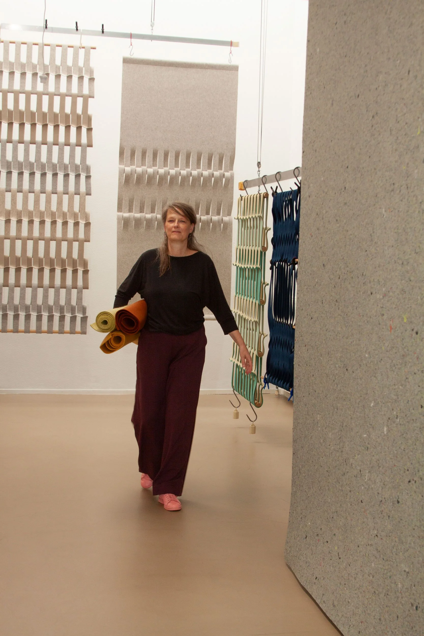Petra Vonk met een rollen textiel in haar rechterarm. 